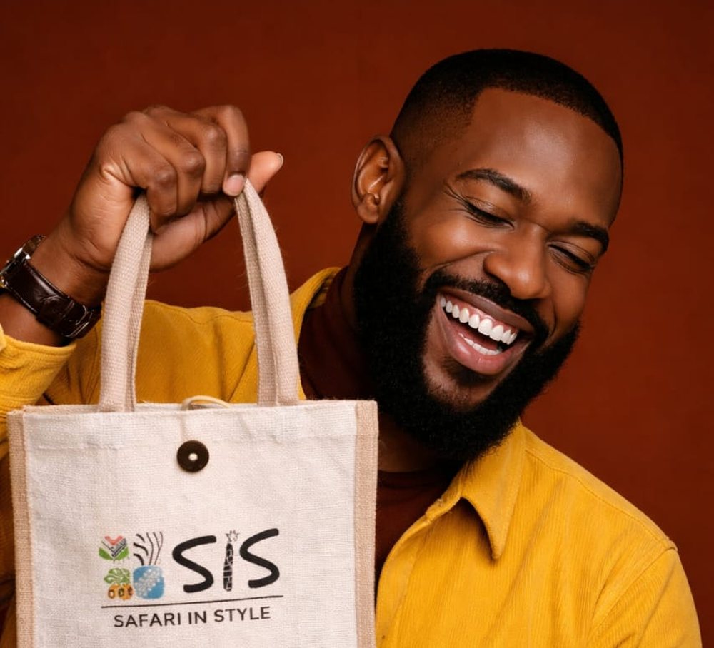 Smiling client holding a custom branded tote bag by HuRu Studios in Arusha, Tanzania
